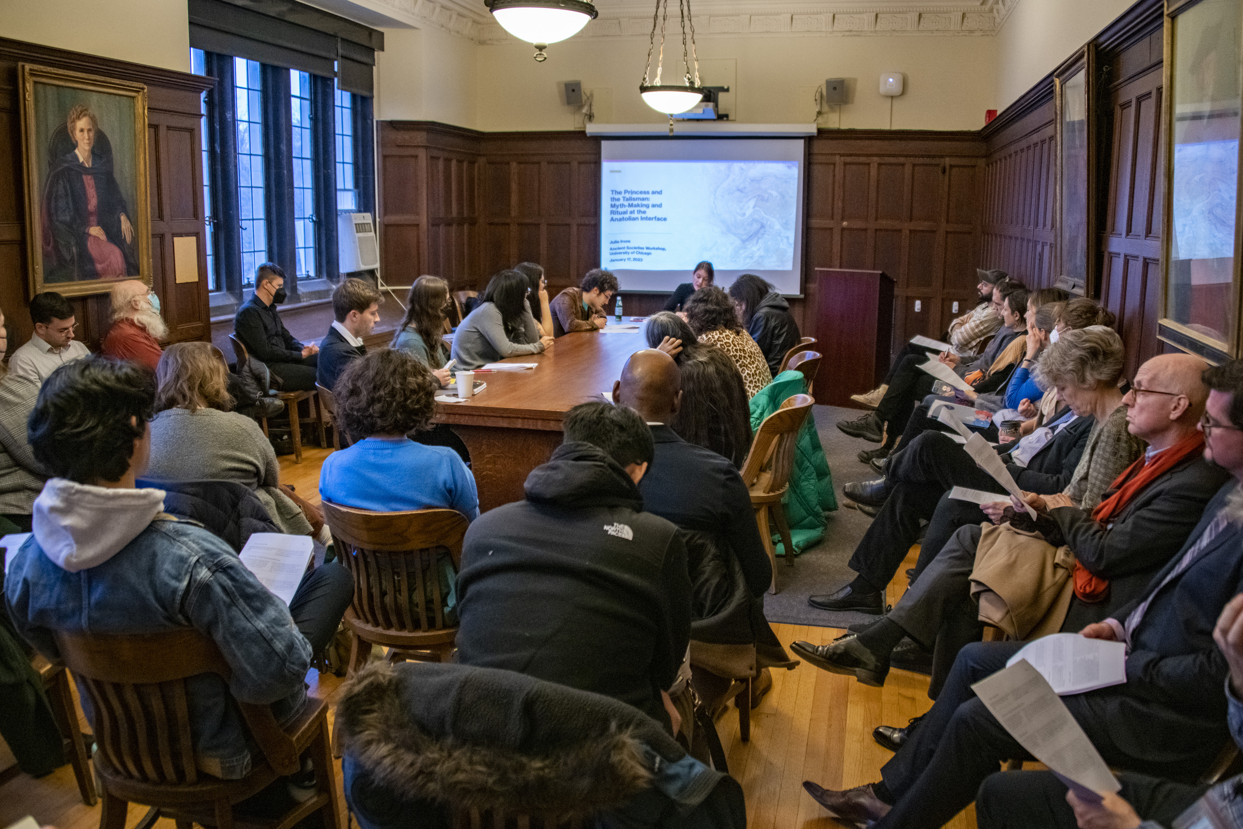 A room full of people with a presenter at the front