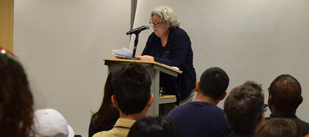 People seated listening to a speaker.